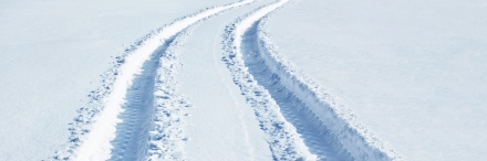 Car tire tracks in snow